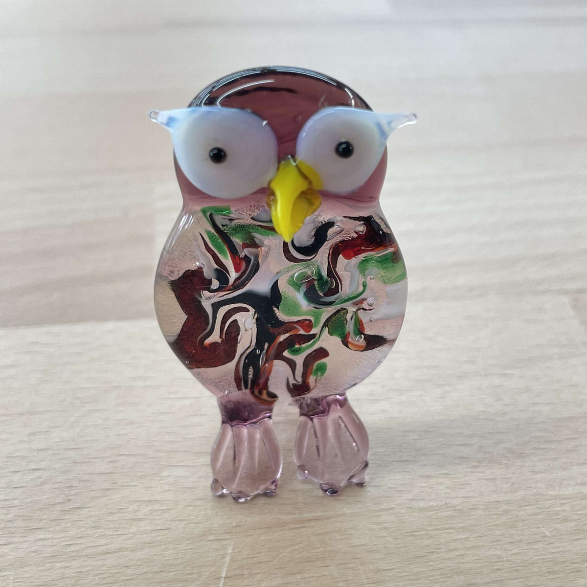 Purple art glass owl figurine with big white eyes and a swirled millefiori body