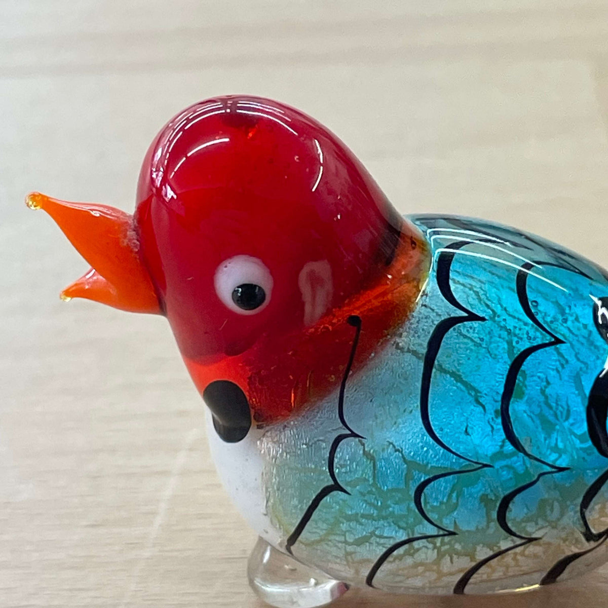 Murano foil glass bird — front view, red head and orange beak