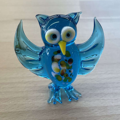 Blue art glass owl figurine with wings up and a millefiori-flecked belly