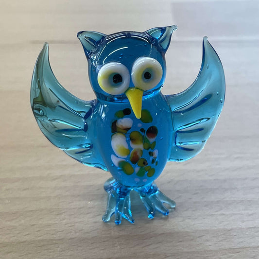 Blue art glass owl figurine with wings up and a millefiori-flecked belly