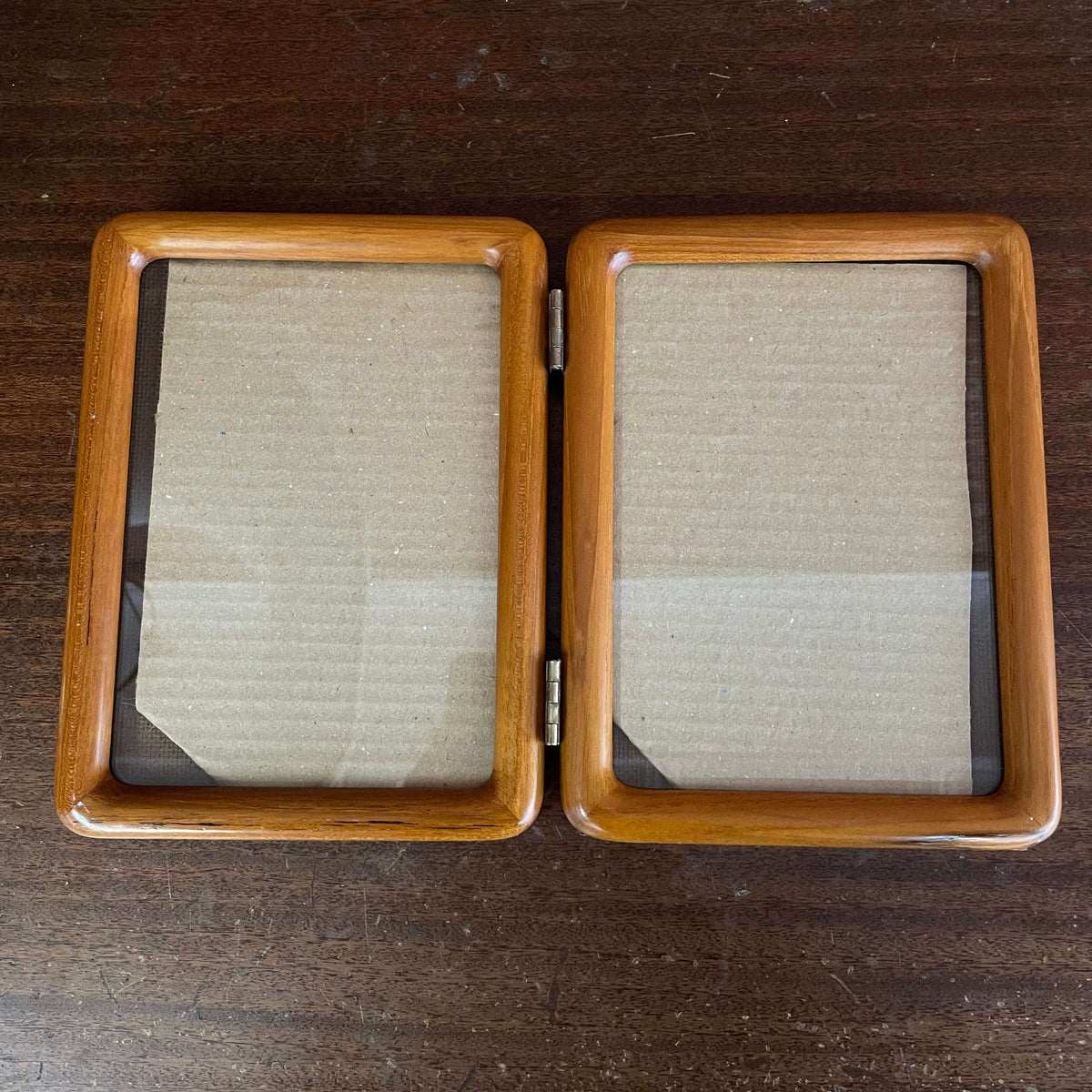 Hinged double wood picture frame — front view of both openings