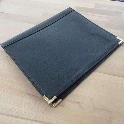 Black leather writing portfolio, closed, with metal corner caps