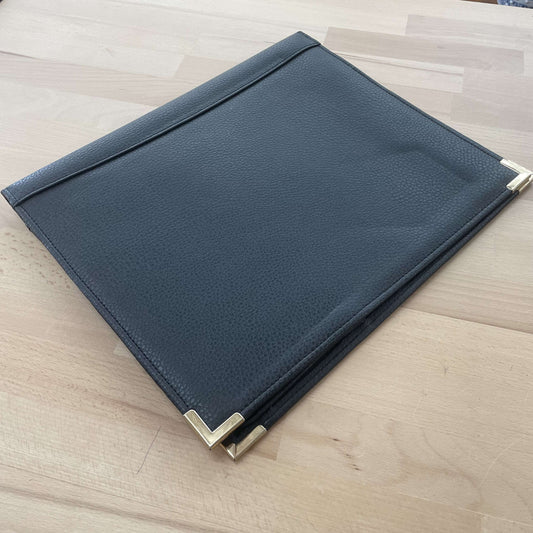 Black leather writing portfolio, closed, with metal corner caps