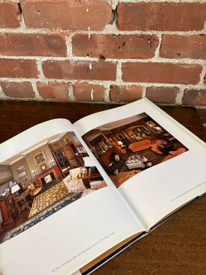 Newport Mansions book open to a gilded interior plate