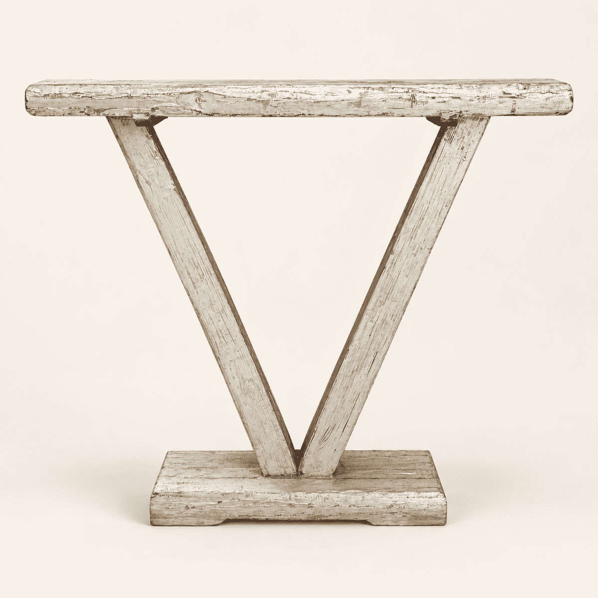 Rustic narrow console table with a sculptural V-shaped base in chippy grey-green paint