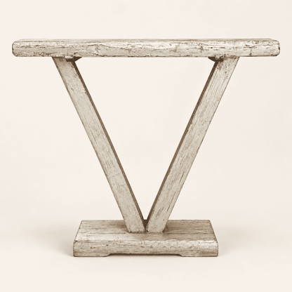 Rustic narrow console table with a sculptural V-shaped base in chippy grey-green paint
