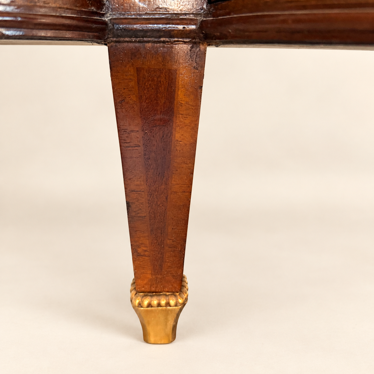 Tapered leg with beaded gilt-brass sabot on the Maitland-Smith commode
