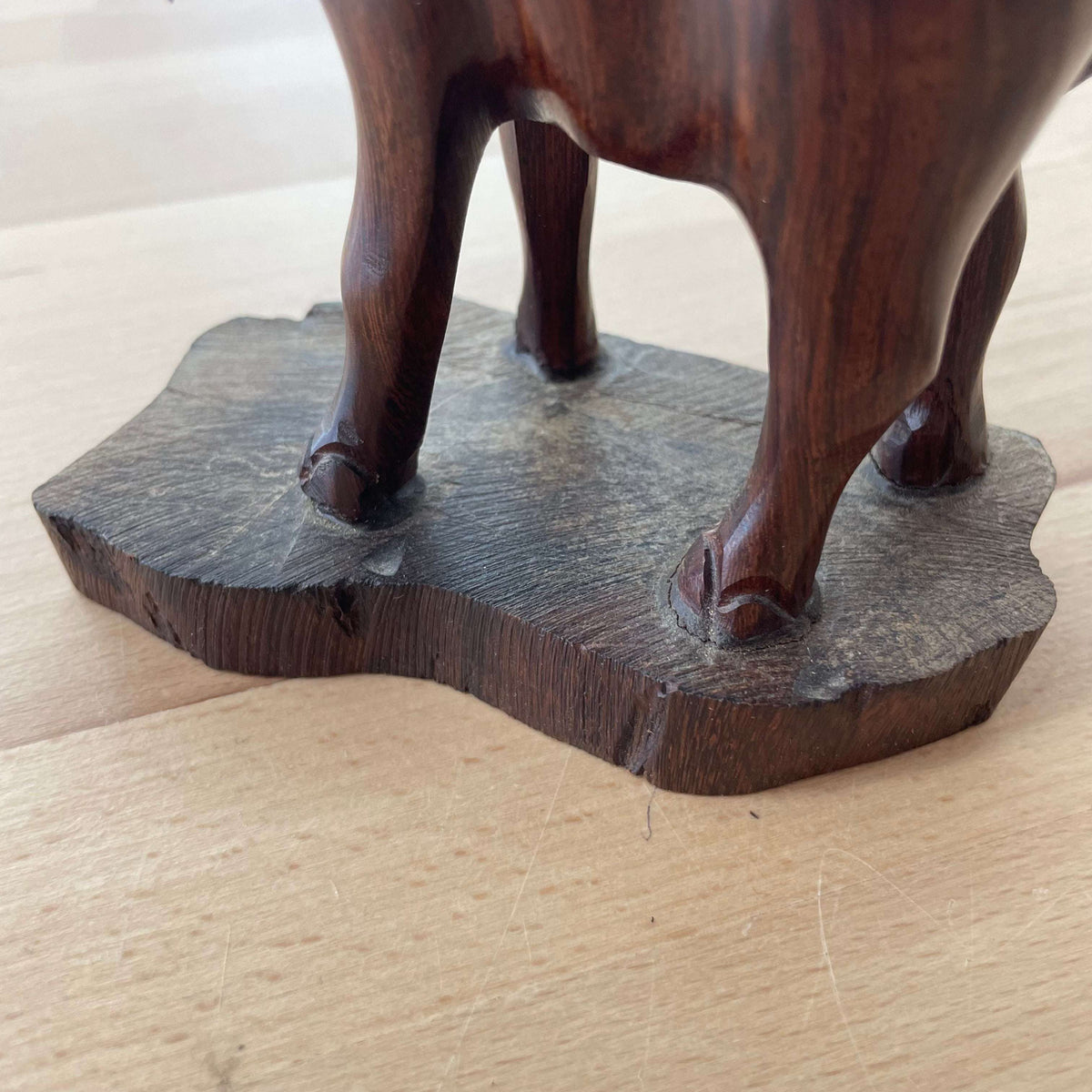 Carved wooden elephant — side profile on the carved base