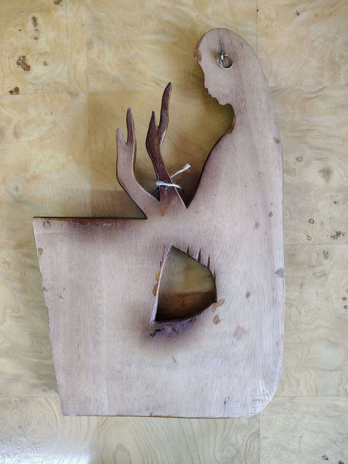 Carved wood wall art — angled view showing relief depth