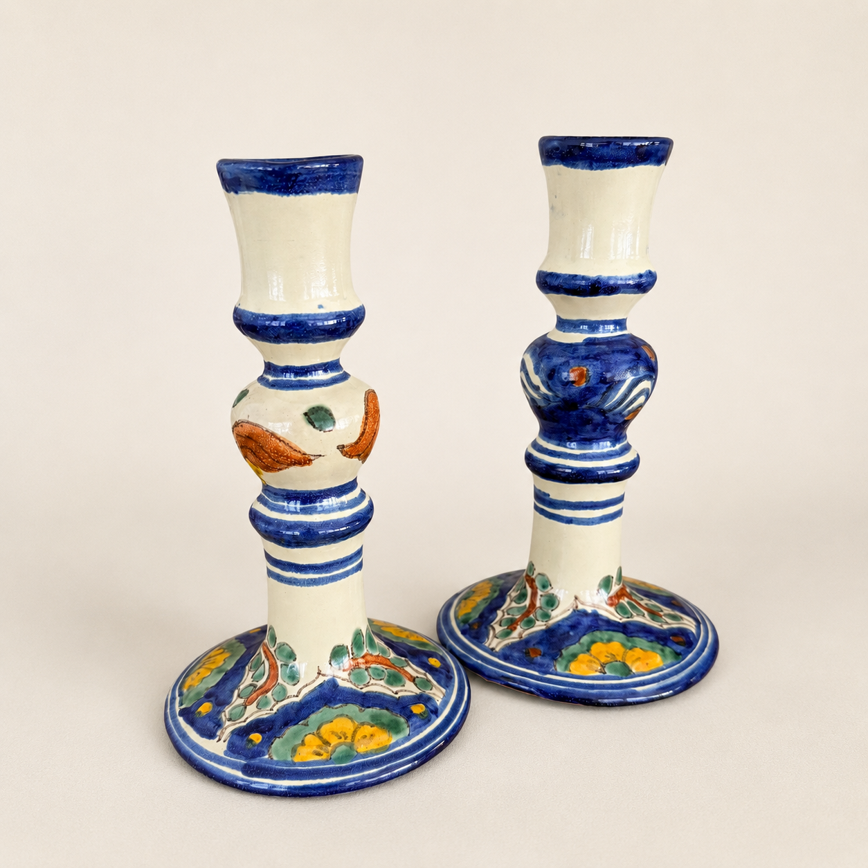 Side view of hand-painted Mexican Talavera candlesticks with turned form