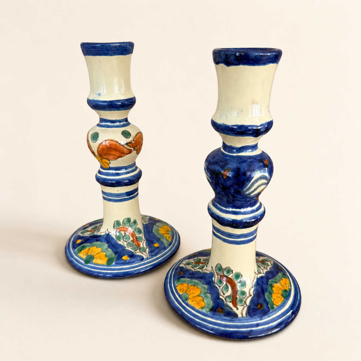 Front view of Mexican Talavera-style candlestick pair with yellow and green florals