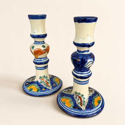 Front view of Mexican Talavera-style candlestick pair with yellow and green florals