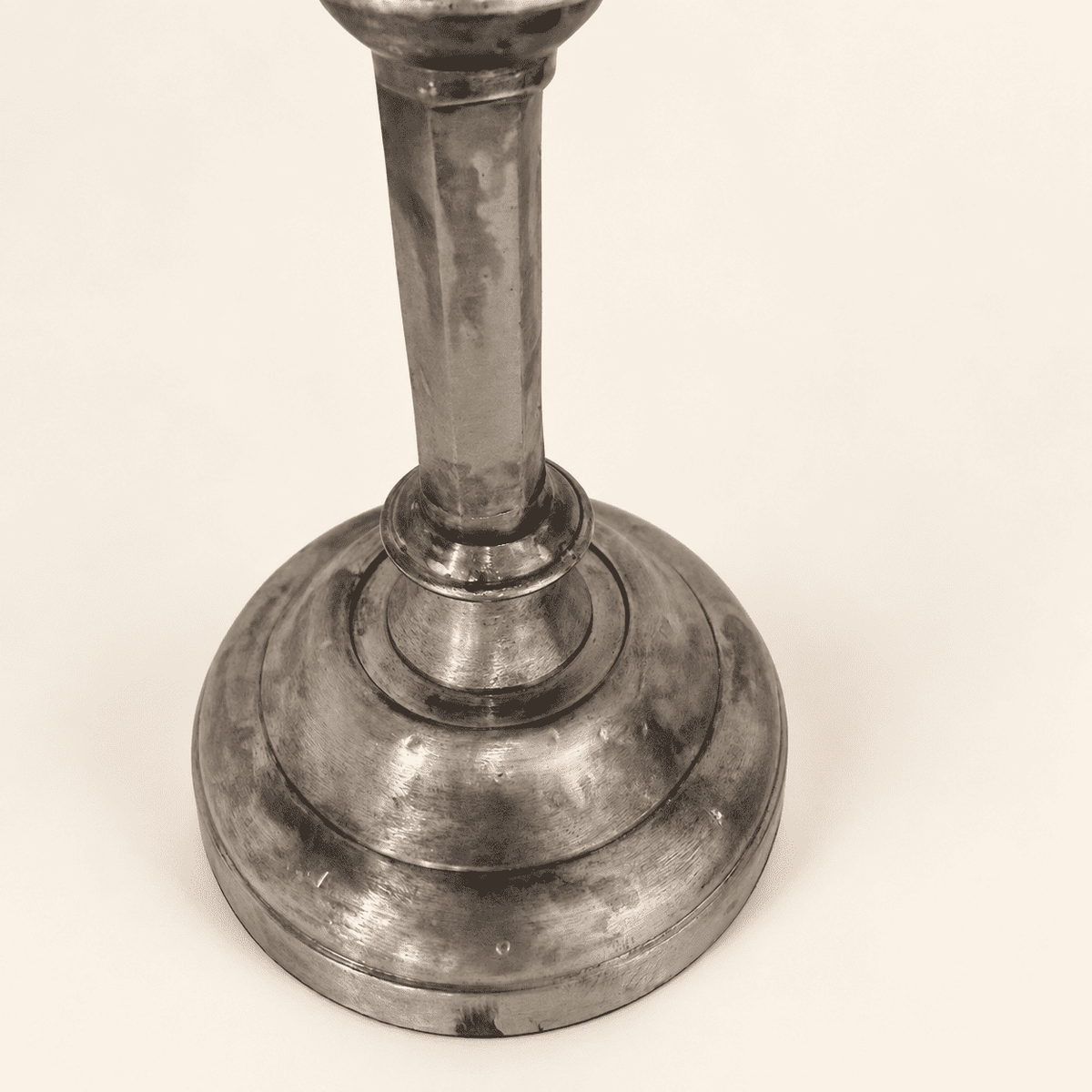 Base and faceted column of a single tarnished Anthropologie candlestick