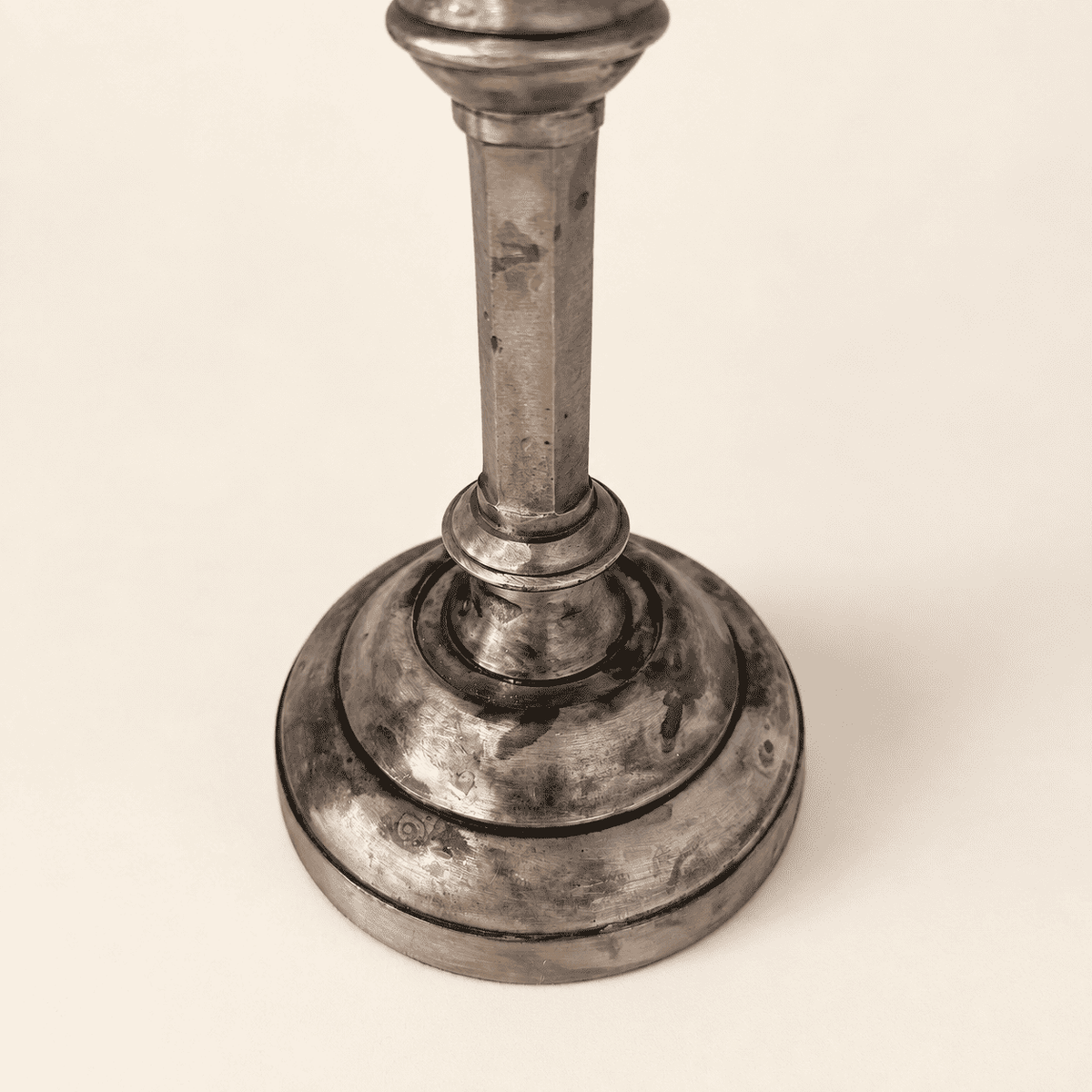 Stepped round base of a single Anthropologie silver candlestick