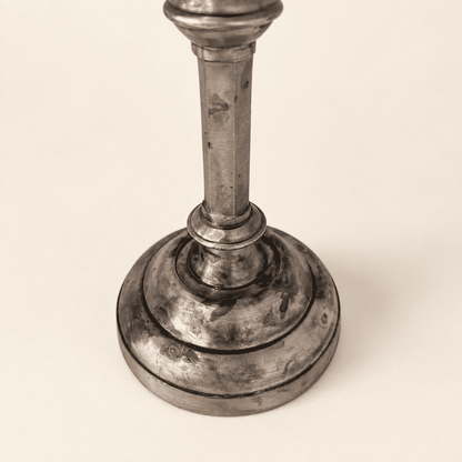 Stepped round base of a single Anthropologie silver candlestick