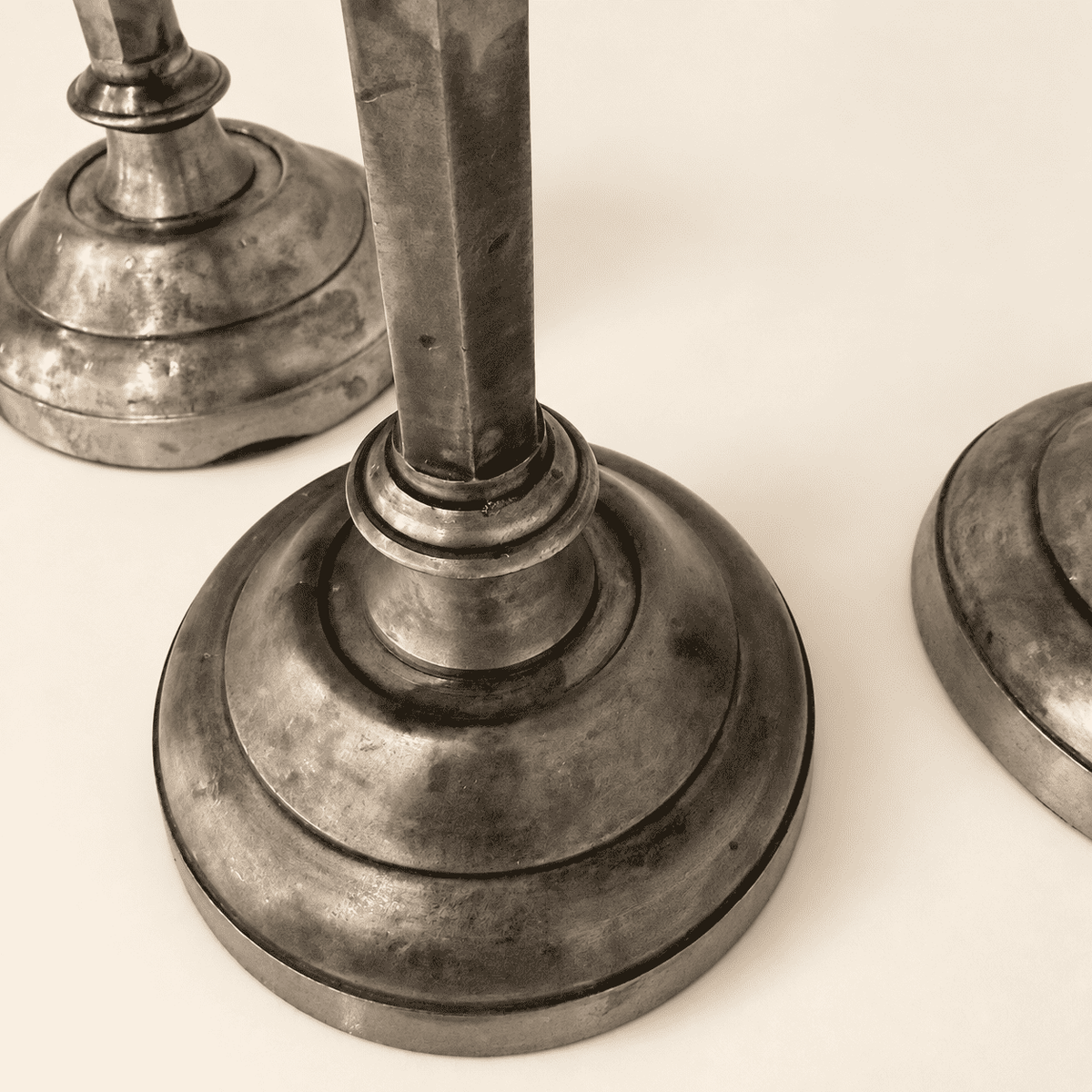 Stepped round bases of the Anthropologie silver candlesticks, angled view