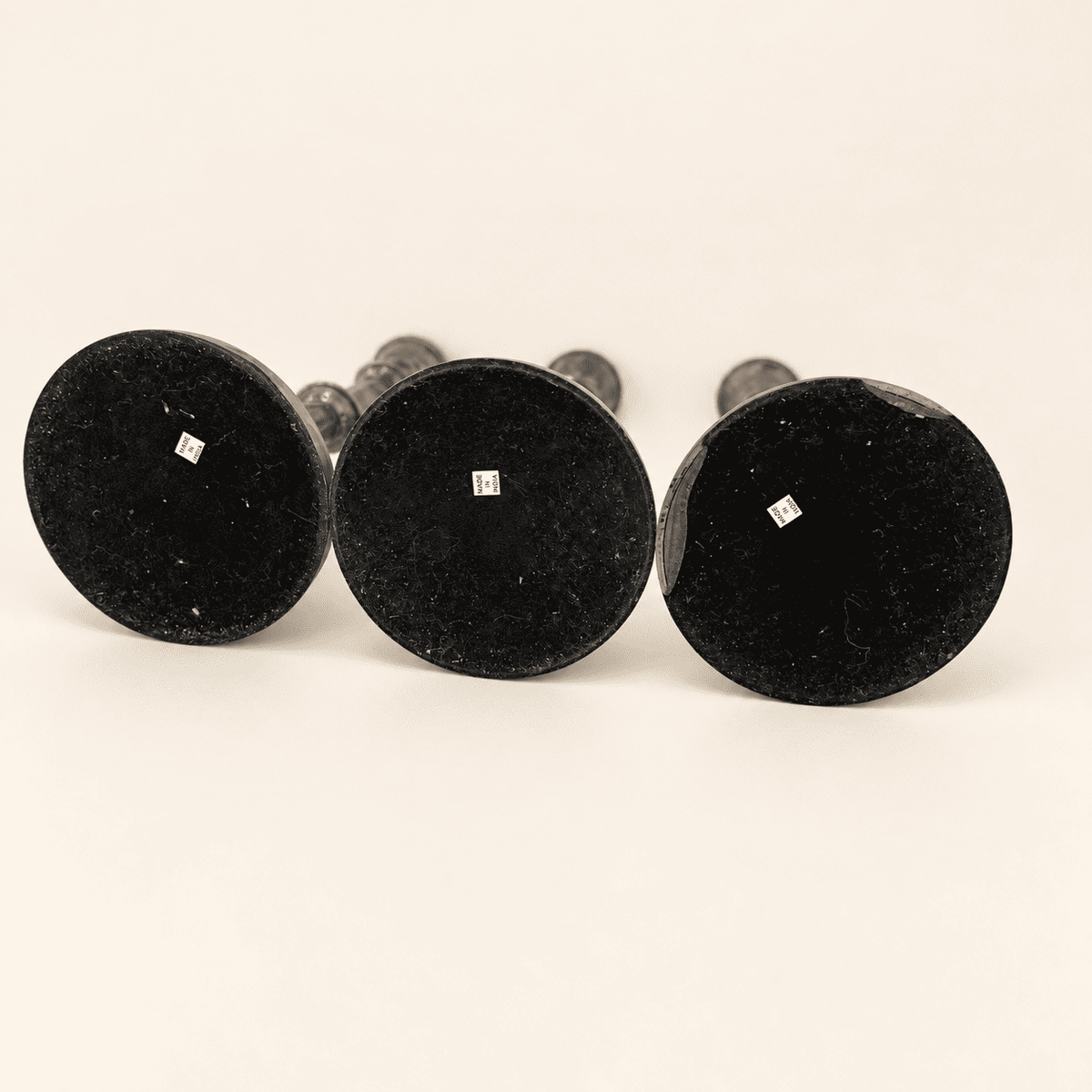 Undersides of the three candlesticks showing Made in India labels