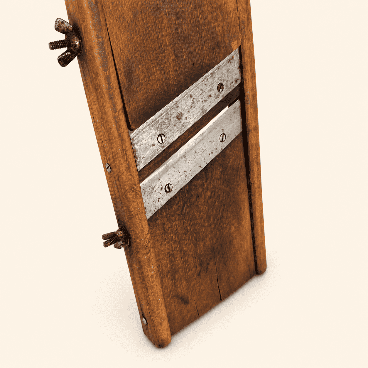 Detail of the wooden handle, keyhole hole, and wing-nut adjuster