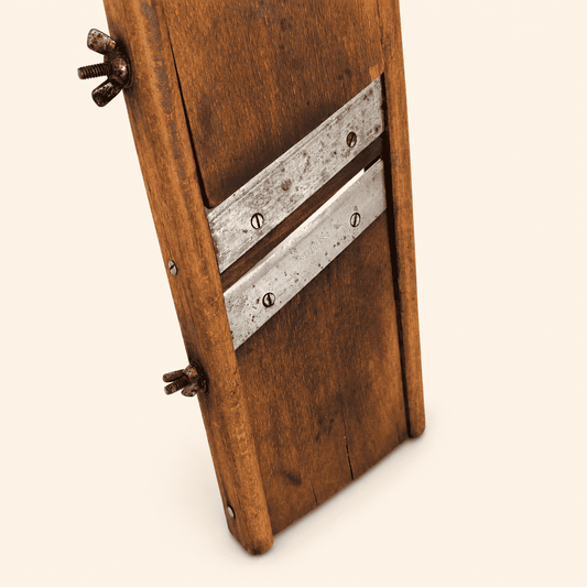 Detail of the wooden handle, keyhole hole, and wing-nut adjuster