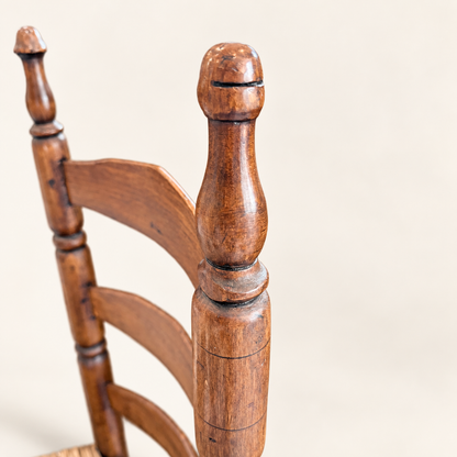 Antique country splint-seat ladder-back chair, angled side view