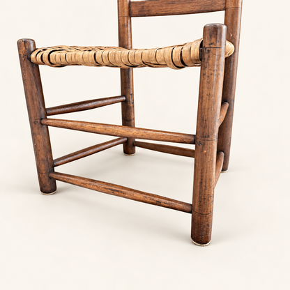 Turned posts and acorn finials on antique ladder-back chair