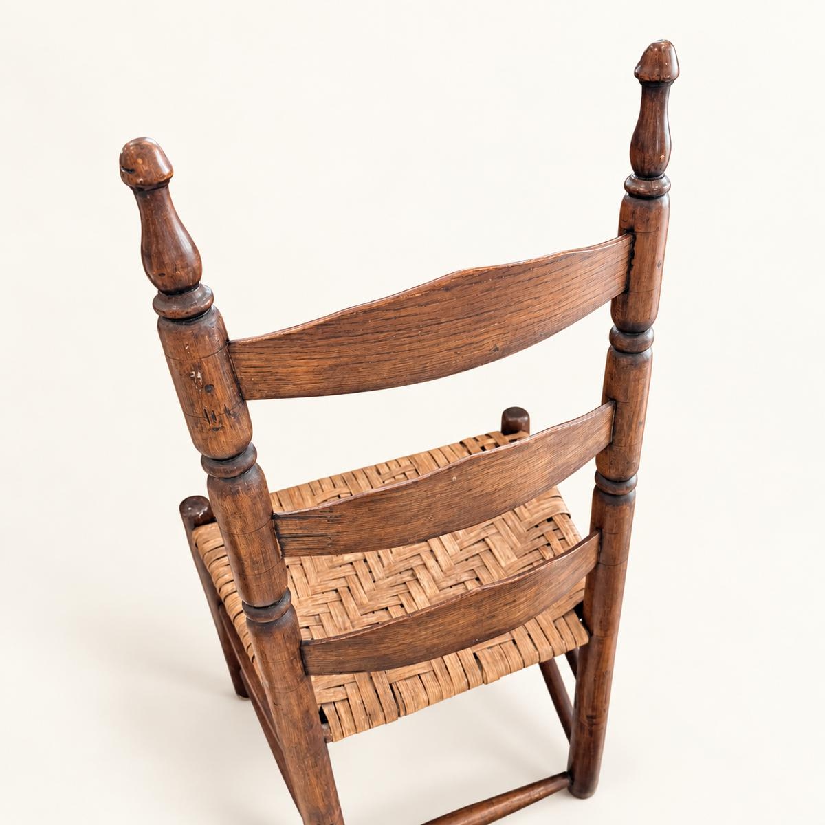 Antique ladder-back chair back view with three curved slats