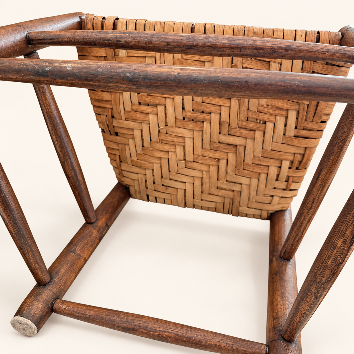 Detail of hand-woven splint seat on antique country ladder-back chair