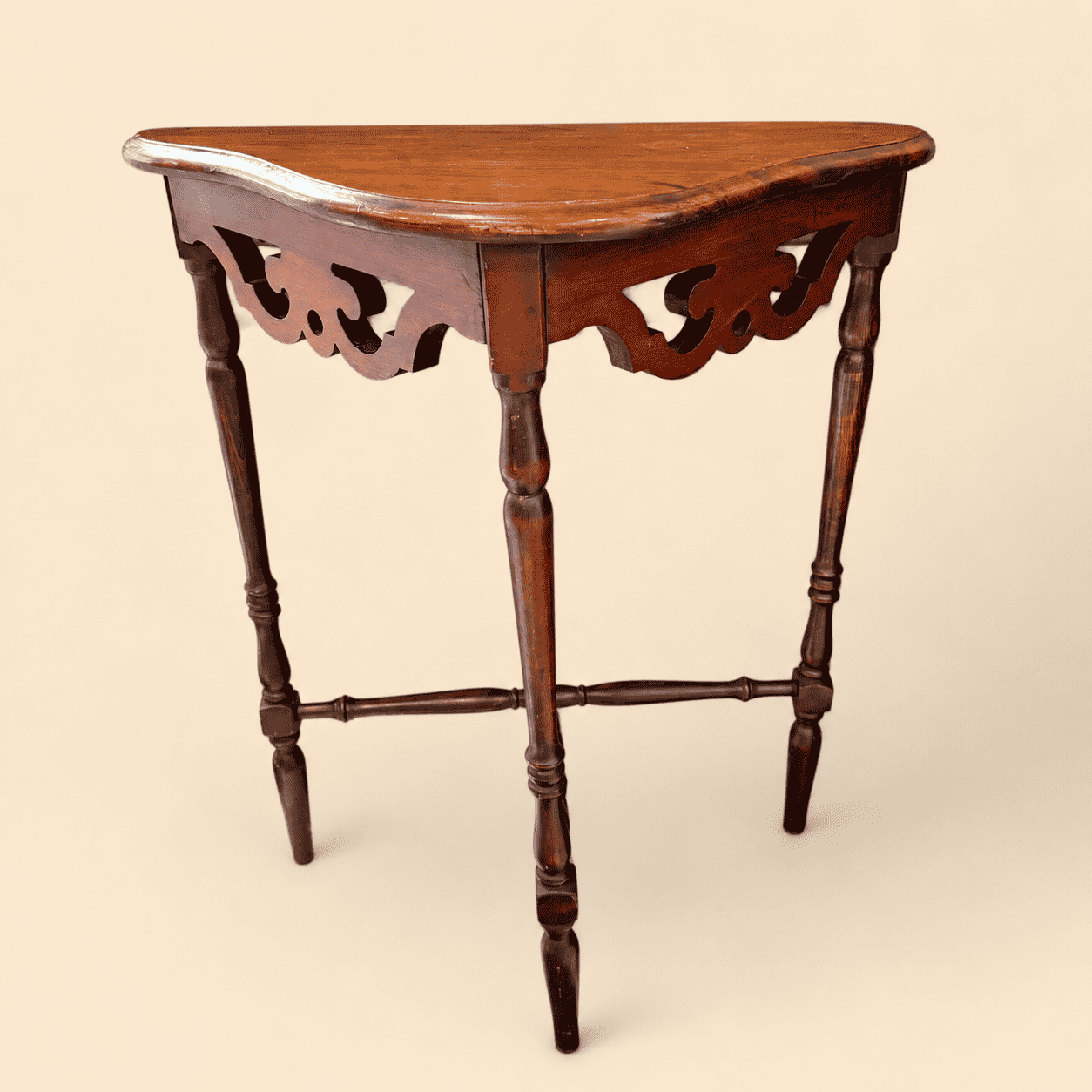 Antique mahogany demilune console table with fretwork apron and turned spindle legs, front view
