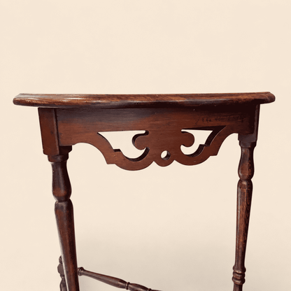 Close-up of the pierced fretwork apron on the antique mahogany demilune console table
