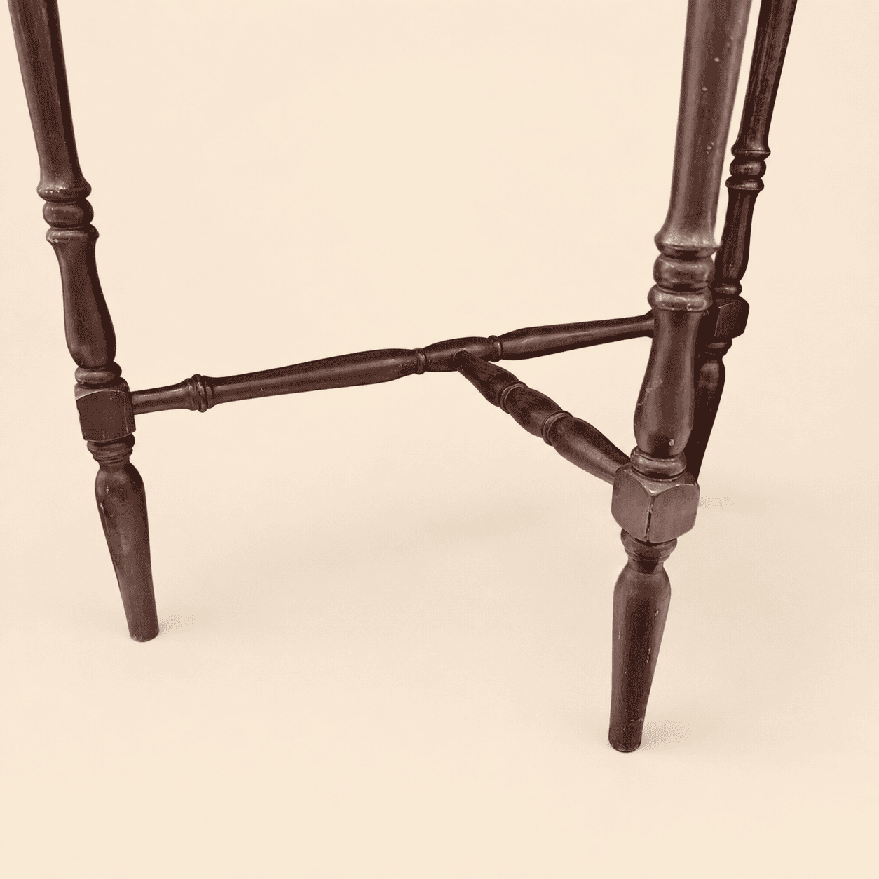 Turned spindle legs and shaped stretcher of the antique demilune console table