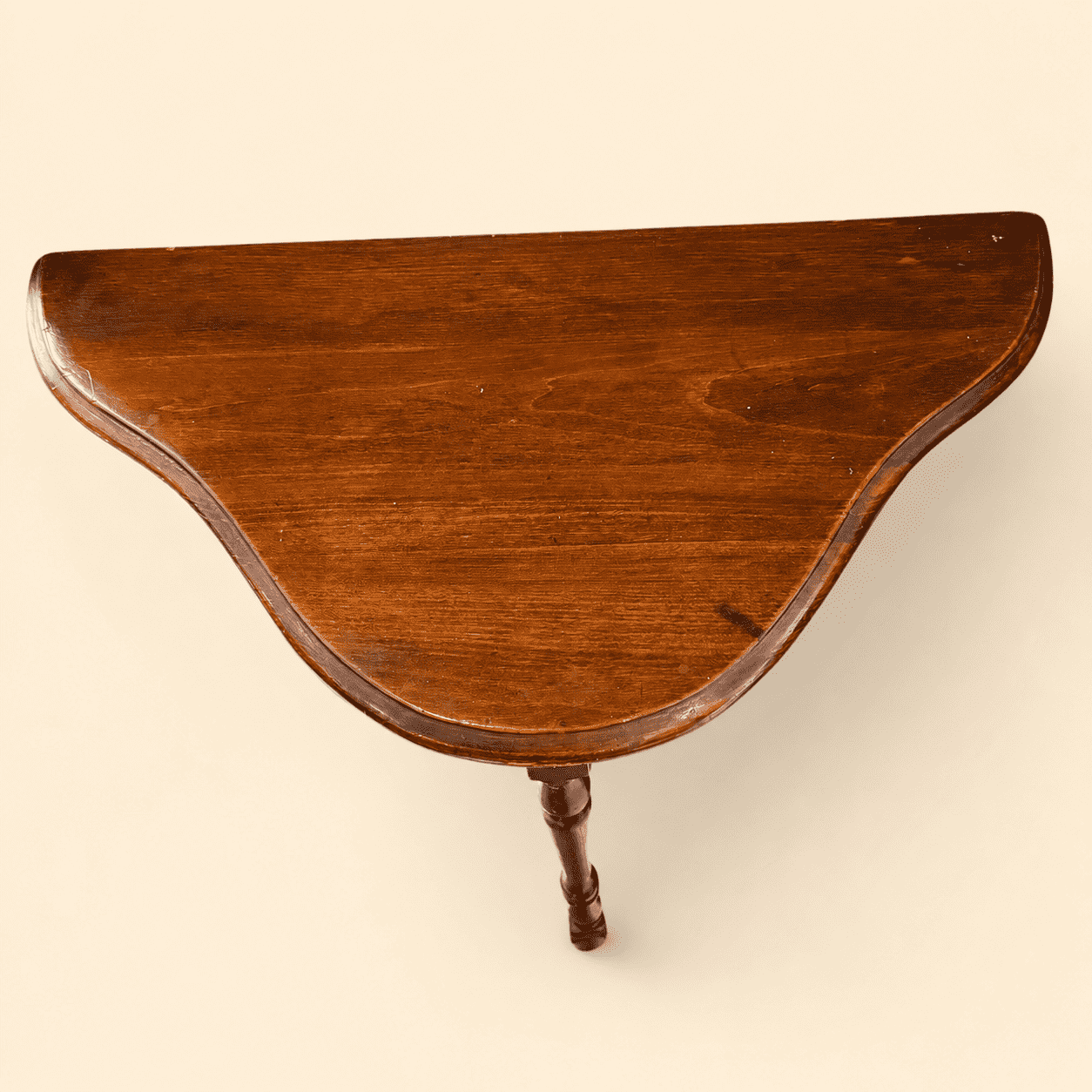 Top surface of the antique mahogany demilune console table showing light age wear