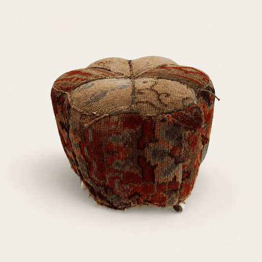 Antique Oriental carpet footstool with hand-knotted rug covering on porcelain casters, front view