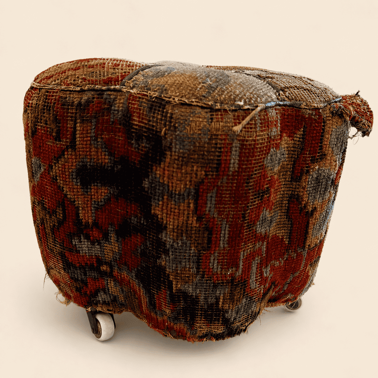 Antique Oriental carpet footstool, side profile view