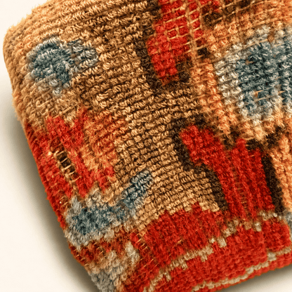 Close-up of the hand-knotted wool carpet pile on the antique footstool