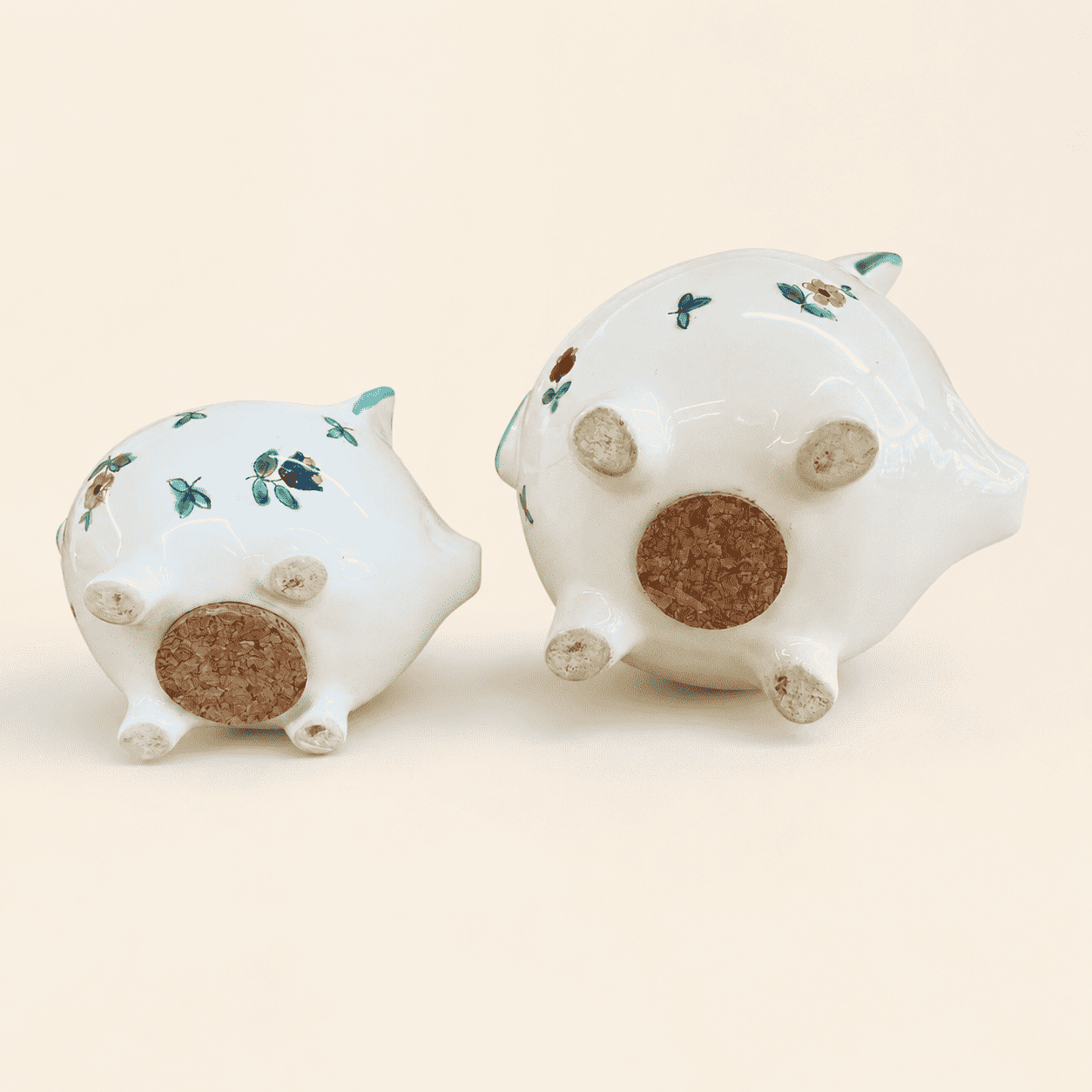 Bases of two Streublumen piggy banks showing round cork stoppers