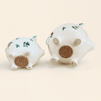 Bases of two Streublumen piggy banks showing round cork stoppers