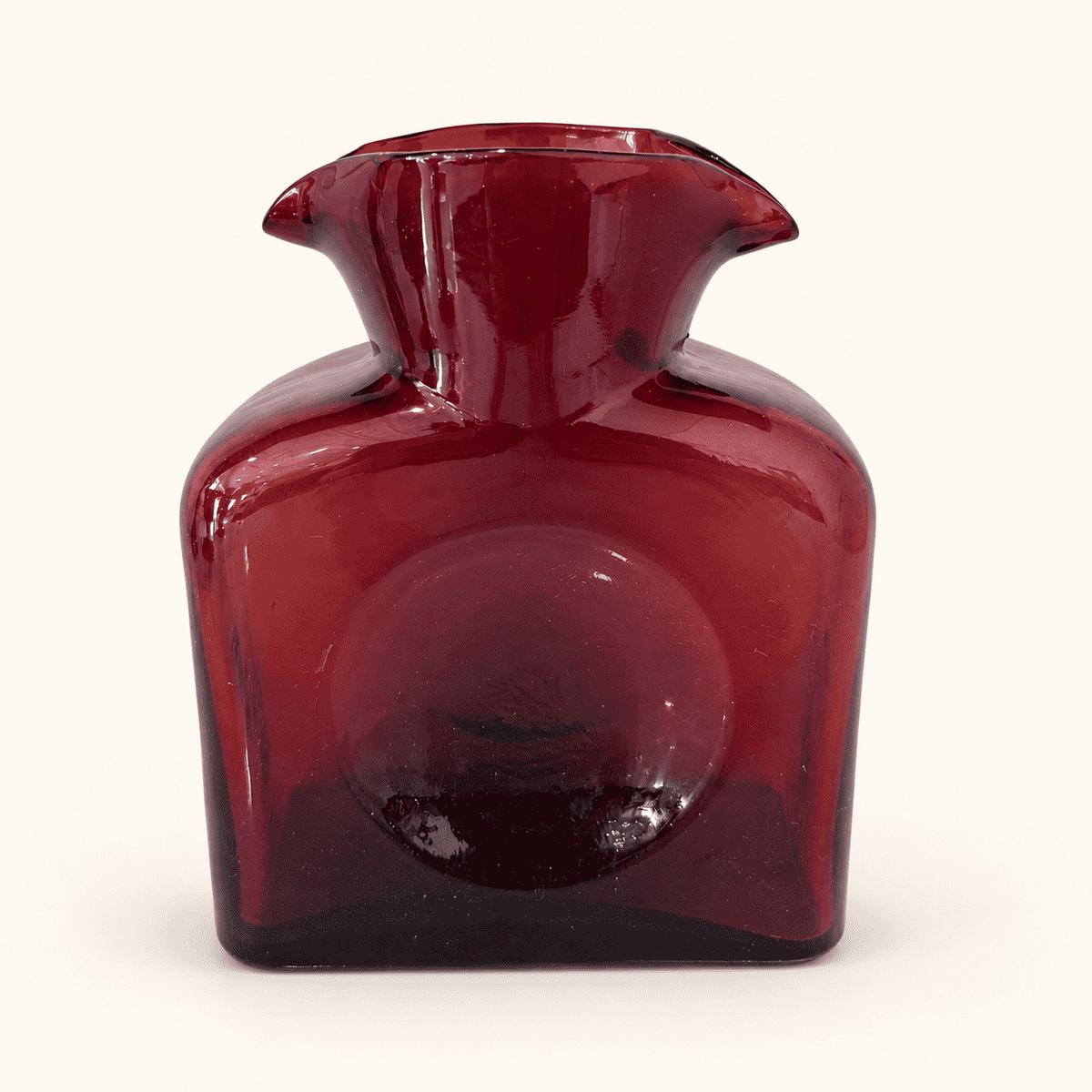Blenko 384 ruby water bottle, straight-on view of the dimpled face