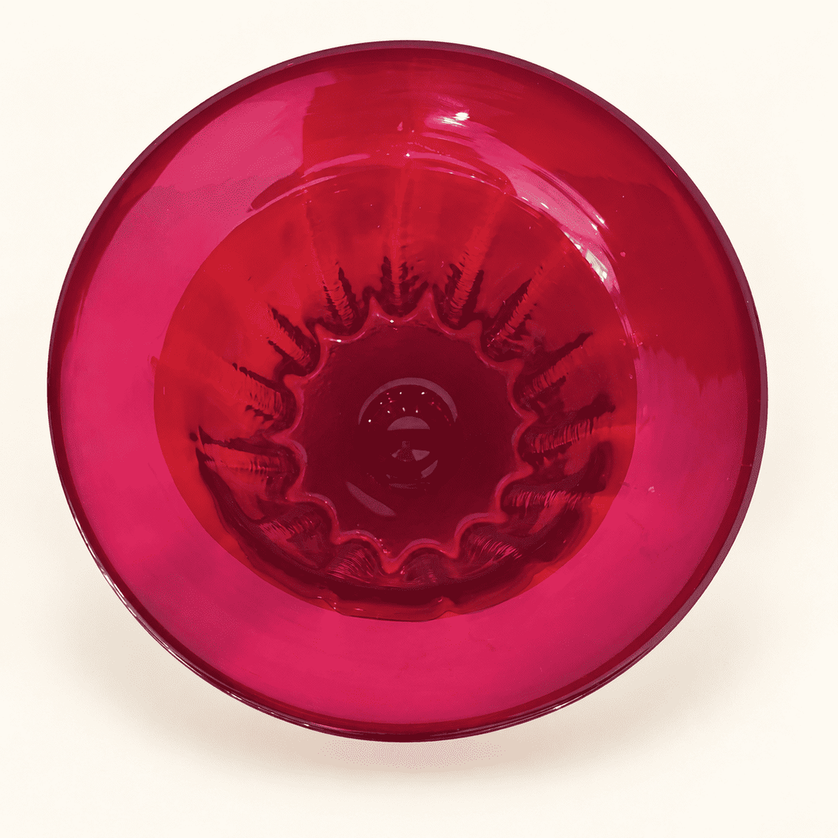 Looking down into the ribbed bowl of a Blenko ruby compote