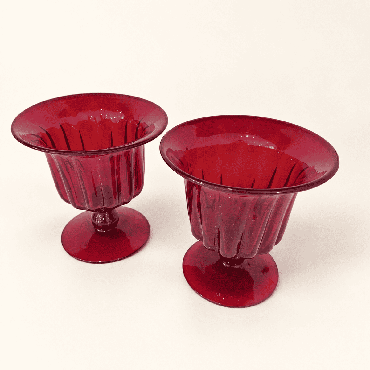 Pair of Blenko ruby ribbed compotes viewed from above at an angle