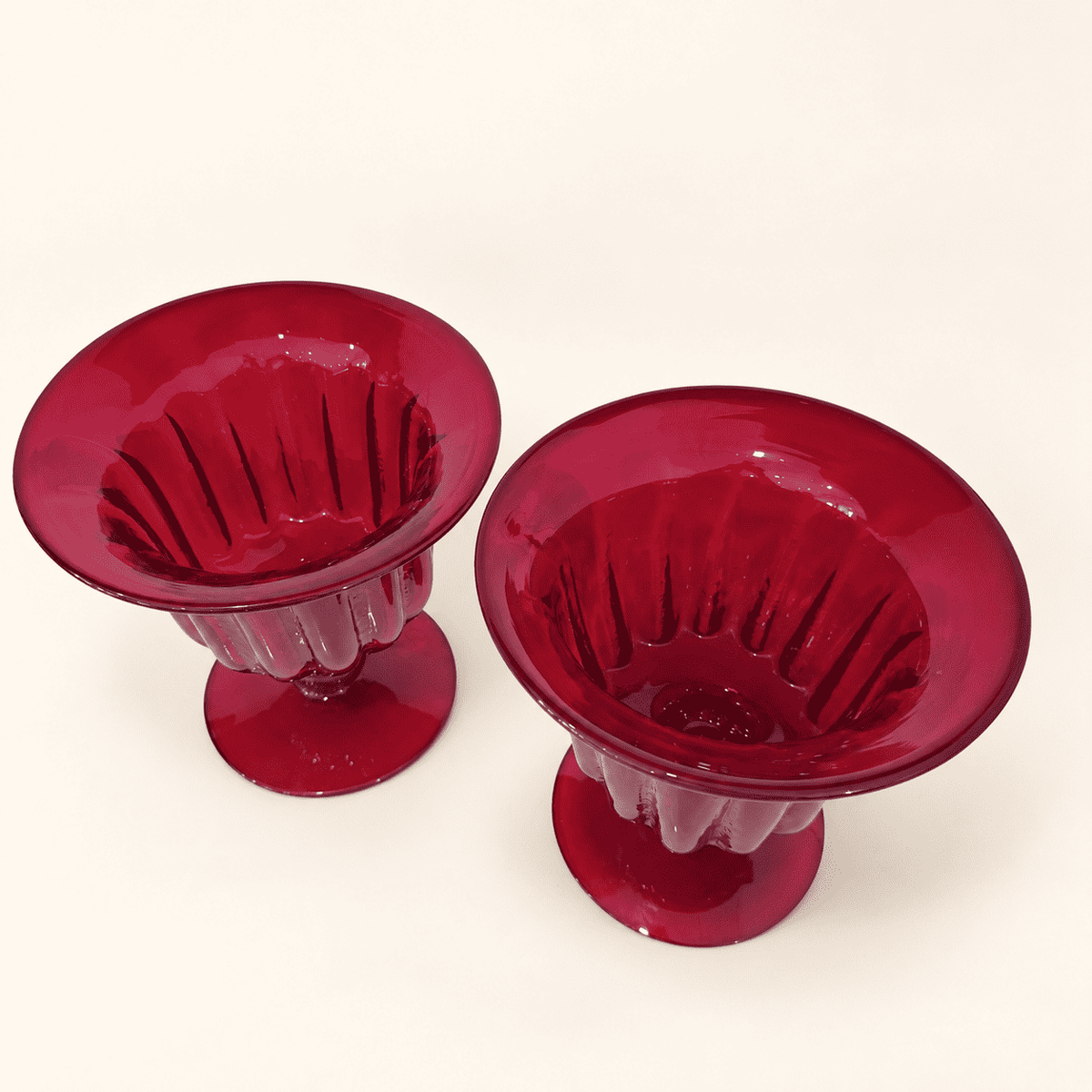 Pair of Blenko ruby compotes from above, showing the ribbed bowls and flared rims
