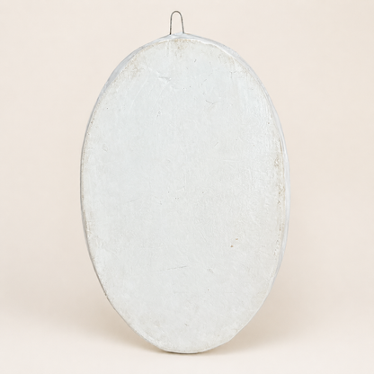Back of oval wall plaque showing wire hanging hook