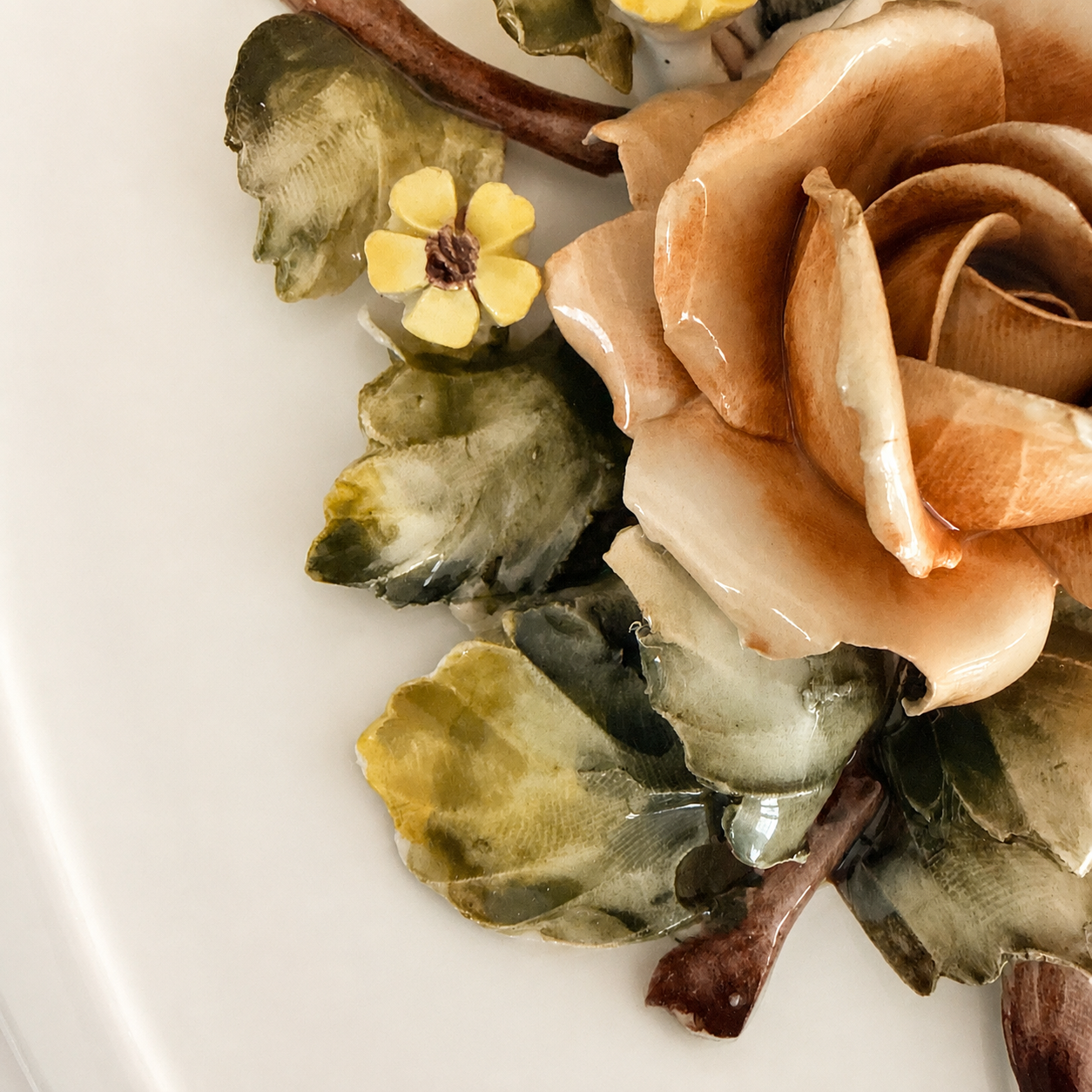 Detail of applied rose and veined ceramic leaves