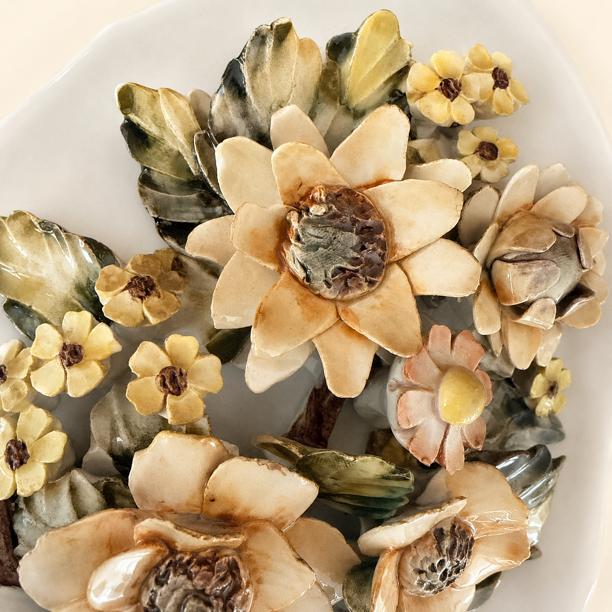 Close-up of applied ceramic sunflower with autumnal glaze
