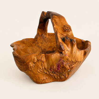Angled view of hand-carved rootwood burl basket with handle