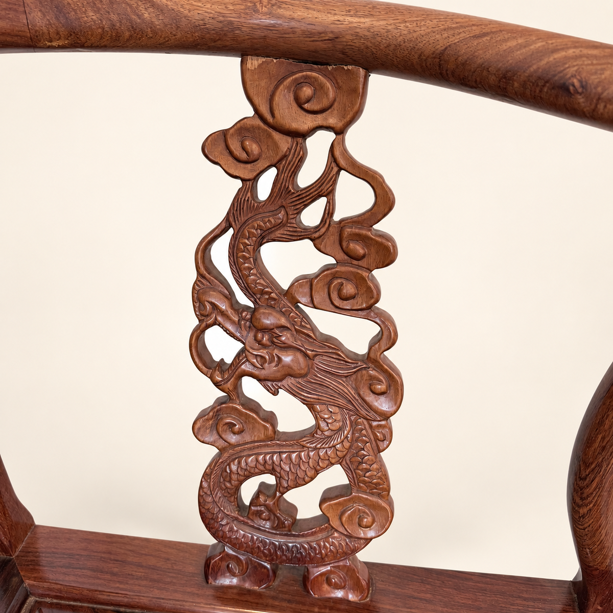 Pair of rosewood horseshoe corner chairs styled together
