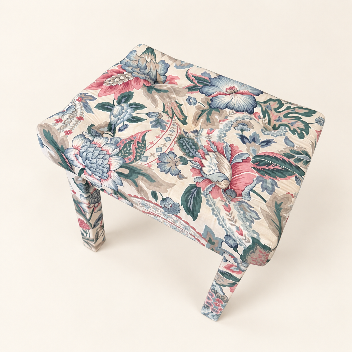 Button-tufted top of pink and blue chintz Parsons stool