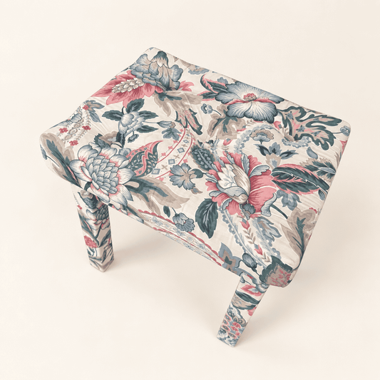 Button-tufted top of pink and blue chintz Parsons stool