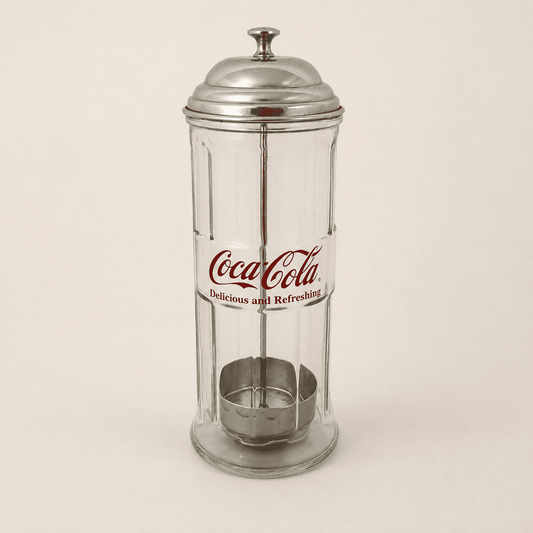 Coca-Cola glass straw dispenser with domed metal lid and red logo, front view