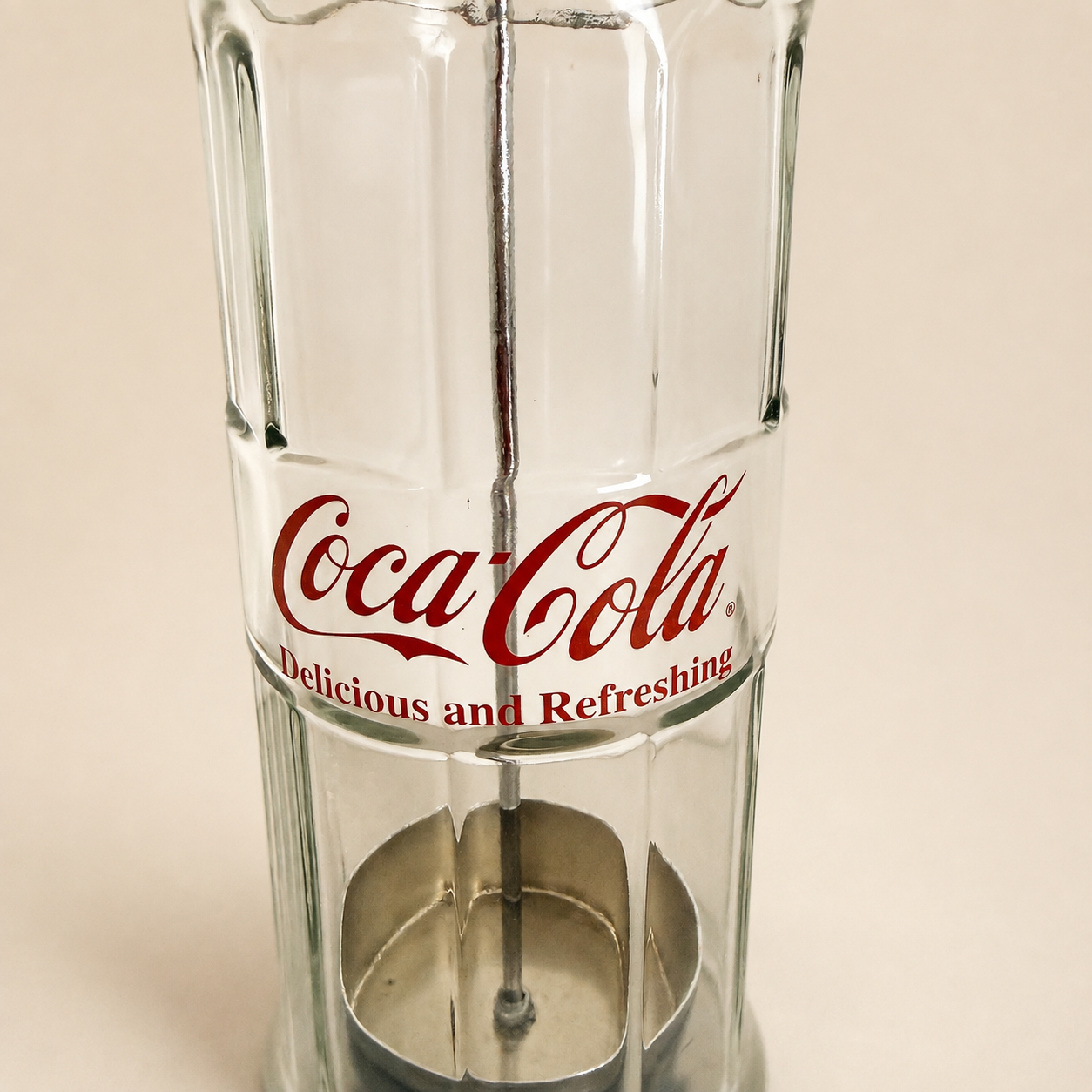 Detail of the metal straw carrier basket inside the glass dispenser