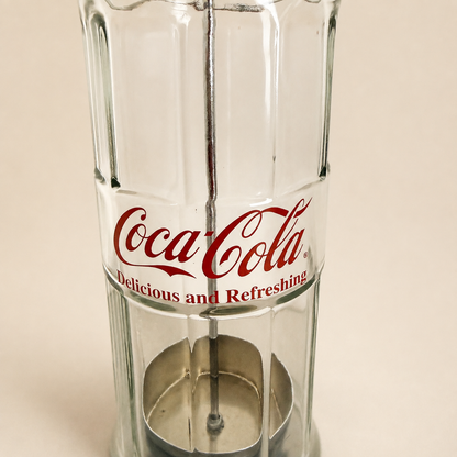 Detail of the metal straw carrier basket inside the glass dispenser